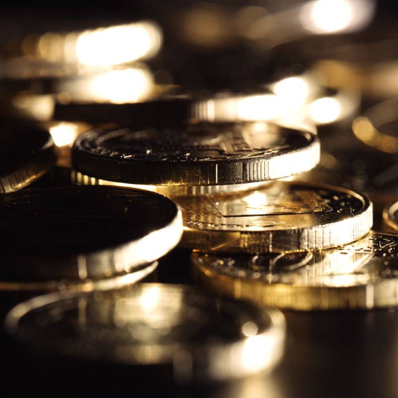 a pile of gold coins on a black background